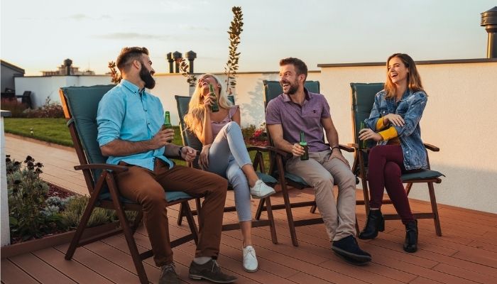 four friends hanging out on a rooftop