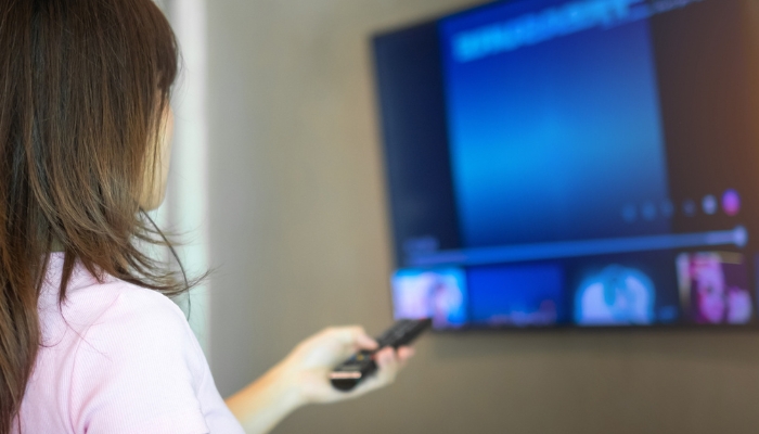 Woman changing the channel