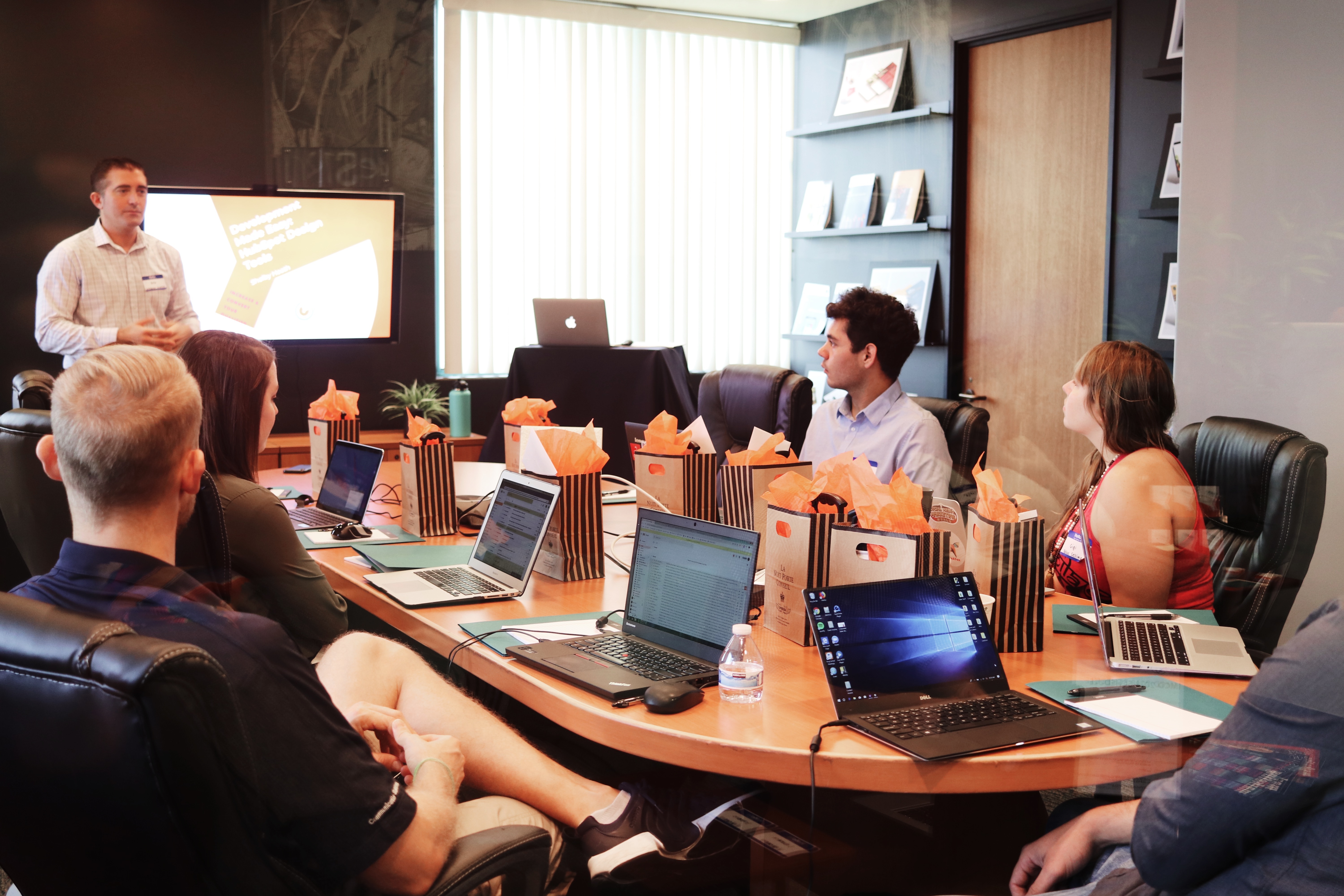 Man presenting presentation in conference room full of people