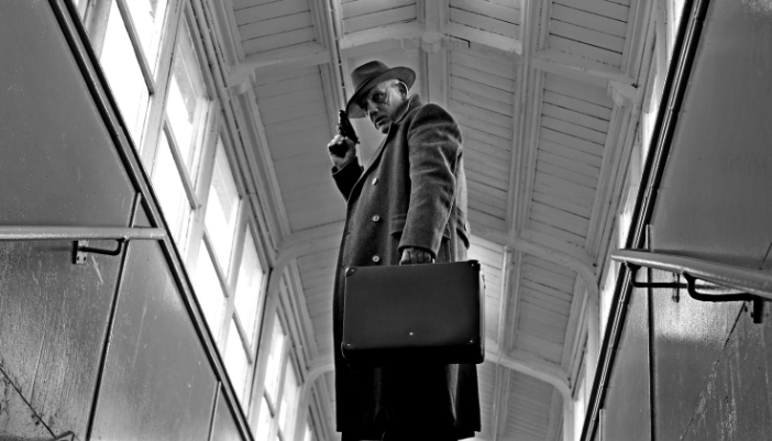 Elec_Classic-Films-Modern-Sound_1.jpg A noir-era style film with a detective looking around with a gun