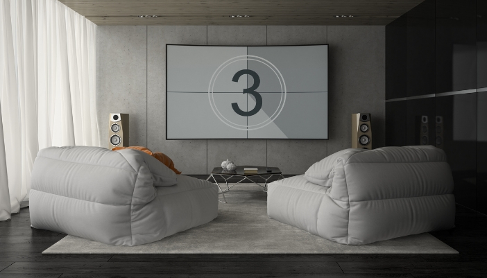 Elec_Classic-Films-Modern-Sound_3.jpg A living room with two floor standing speakers and a movie about to play