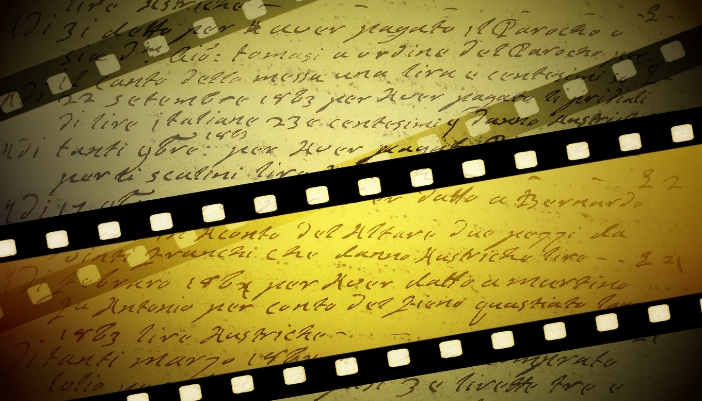 Film strips in different coloring over an image of handwriting