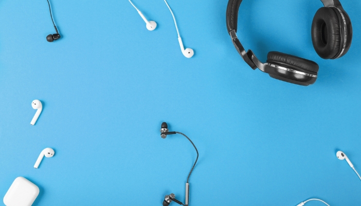 An array of headphones against a blue background