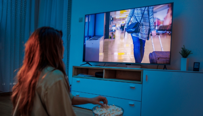A woman watching TV with ideal settings and lighting