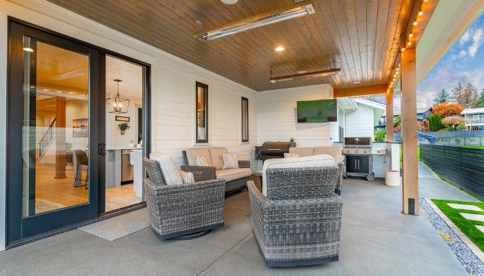 An outdoor TV setup in back patio kitchen near water