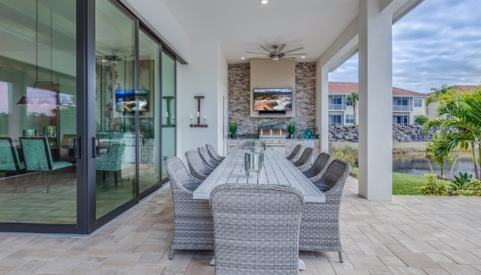 A TV placed in a covered patio over grill, able to withstand lots of heat