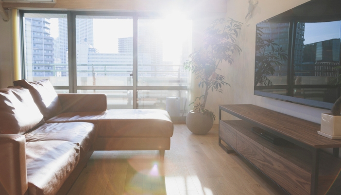 A bright glare from the sun hits a living room TV. 
