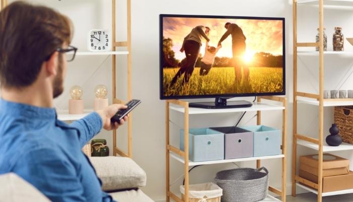 Man watching TV with super high resolution