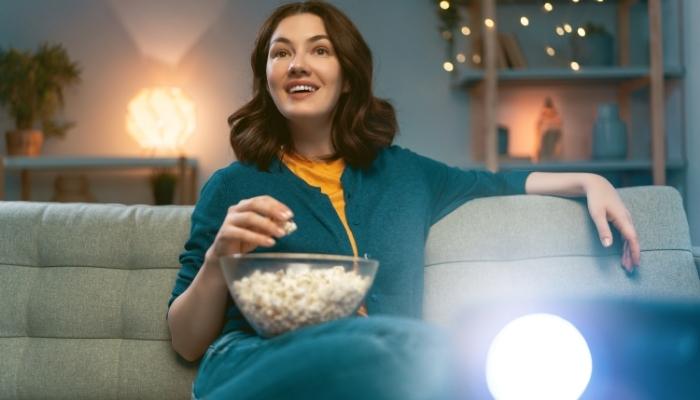 Woman watching bright projected screen