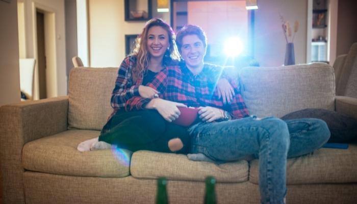 Couple watching projector screen