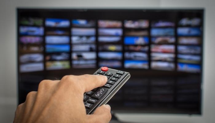 Person scrolling through TV apps