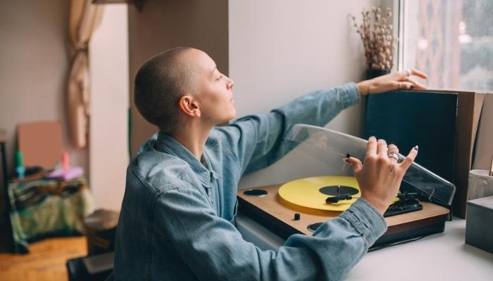 woman using her vinyl record player