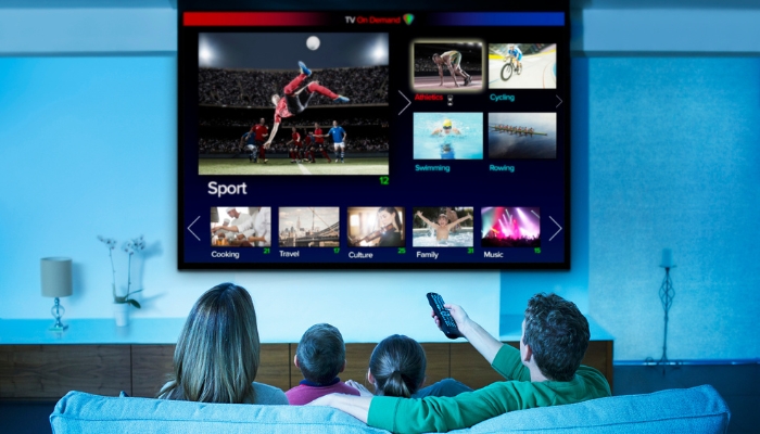 Family choosing what to watch on a huge projector screen