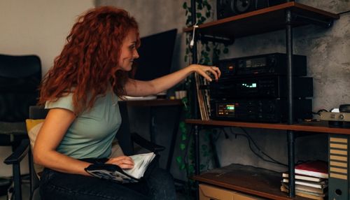 Woman Listening to CD with Luxury Audio System