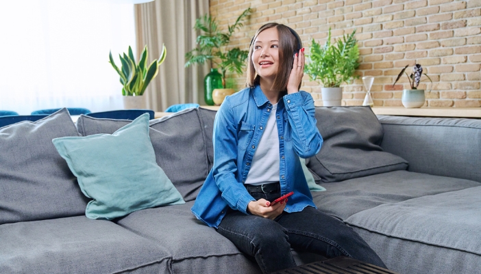 Woman checking the sound on her headphones before event