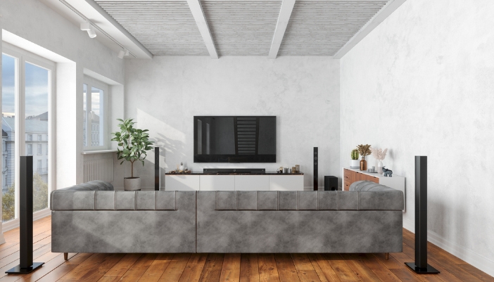A living space with a soundbar and surrounding speakers