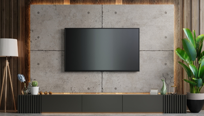 A living space with a TV mounted on a wall, screen off