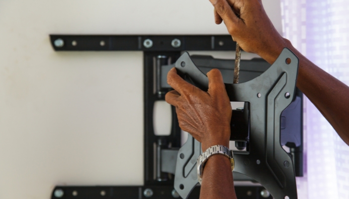Closeup of someone installing a wall mount
