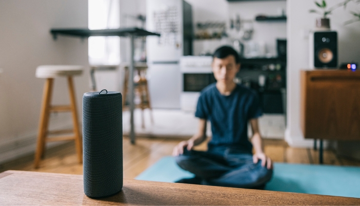 Man using Bluetooth speakers to meditate