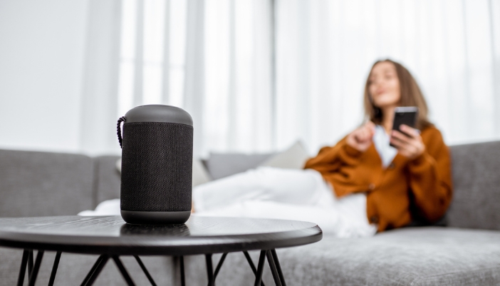 Woman using her Wi-Fi speaker to connect to her devices
