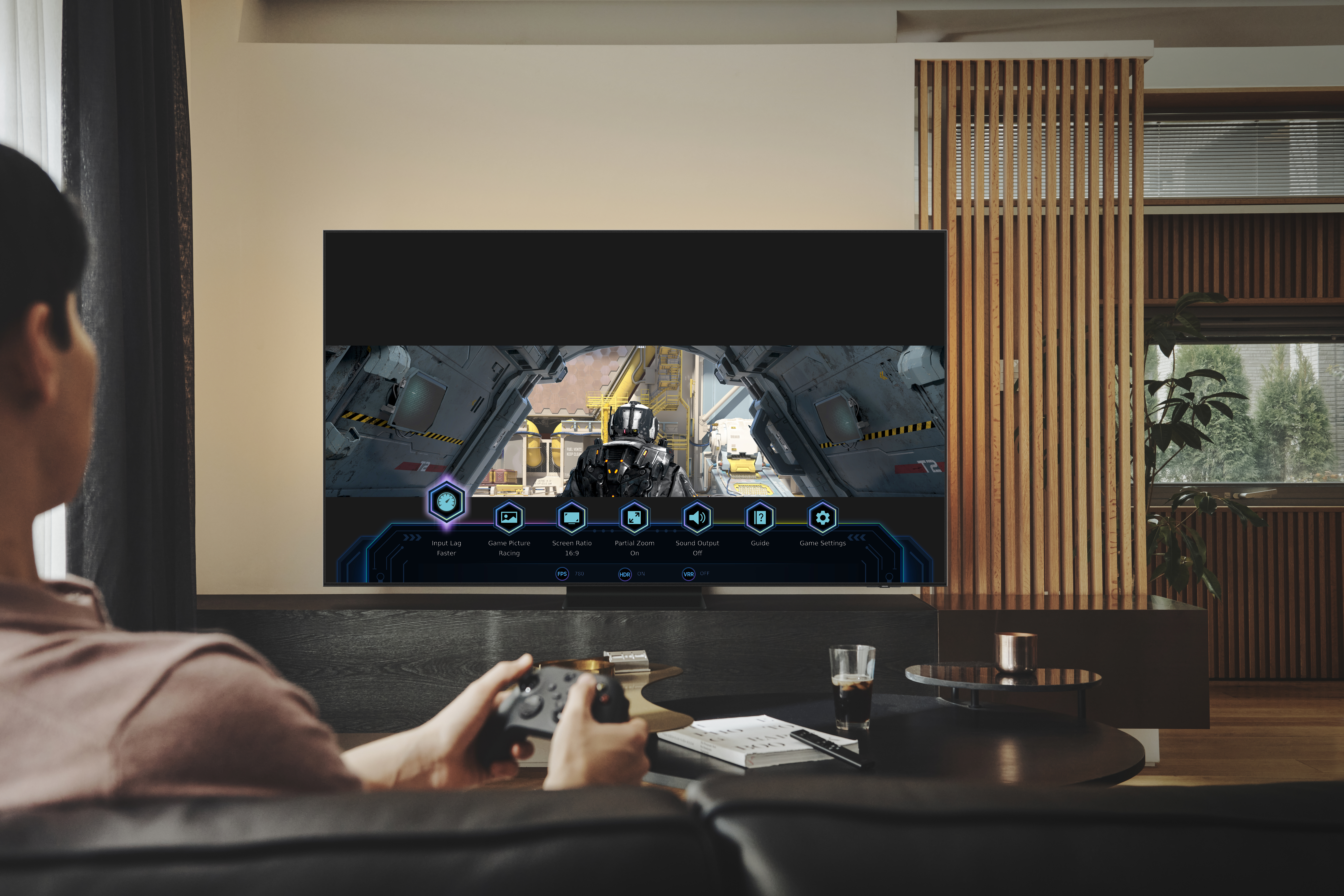 man on couch playing video game on Samsung TV 