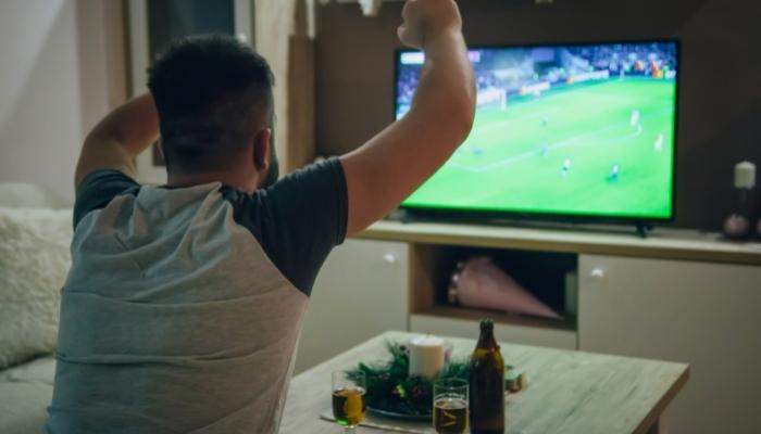 Man watching sports on TV