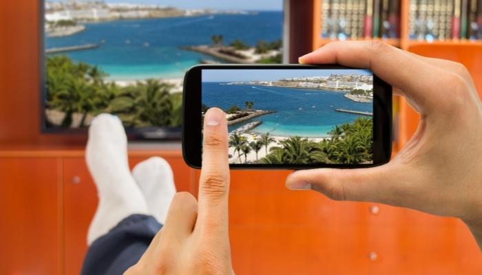 Person streaming from smartphone to TV