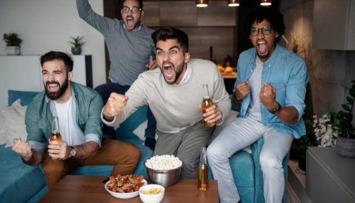 Group of friends cheering on game