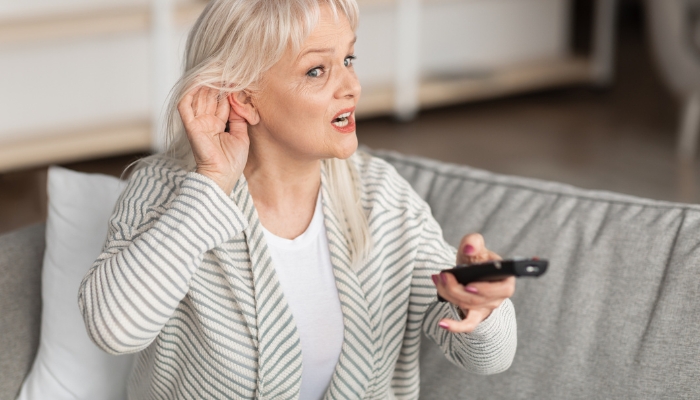 Woman having trouble hearing the TV