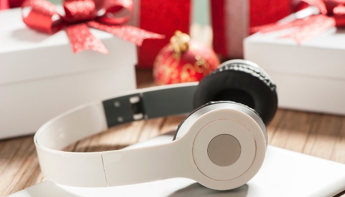 Headphones lying in front of Christmas presents, just opened