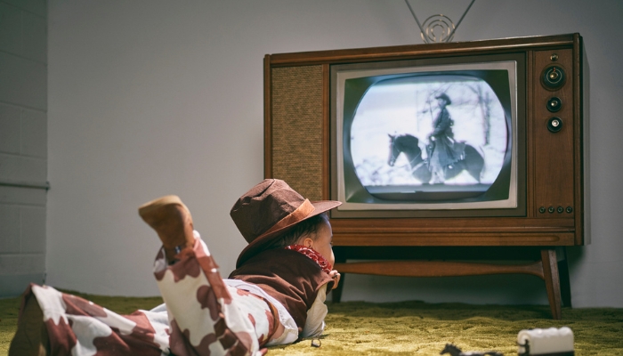 Toddler watching western on old black-and-white TV