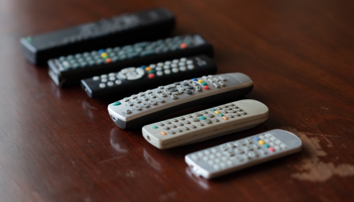 A collection of remotes on the living room coffee table