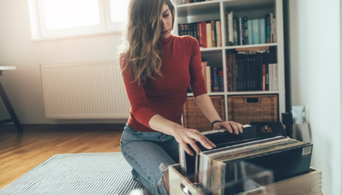 Woman combing through her collection of vinyl records