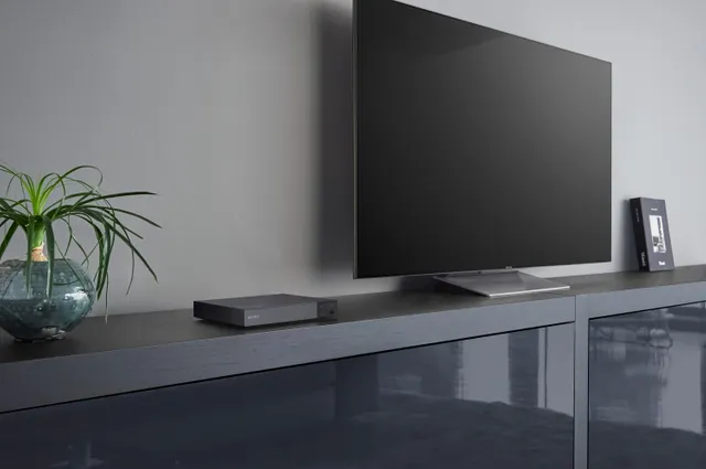 A wide shot of the Sony BDPS6700 Blu ray player on an entertainment center 