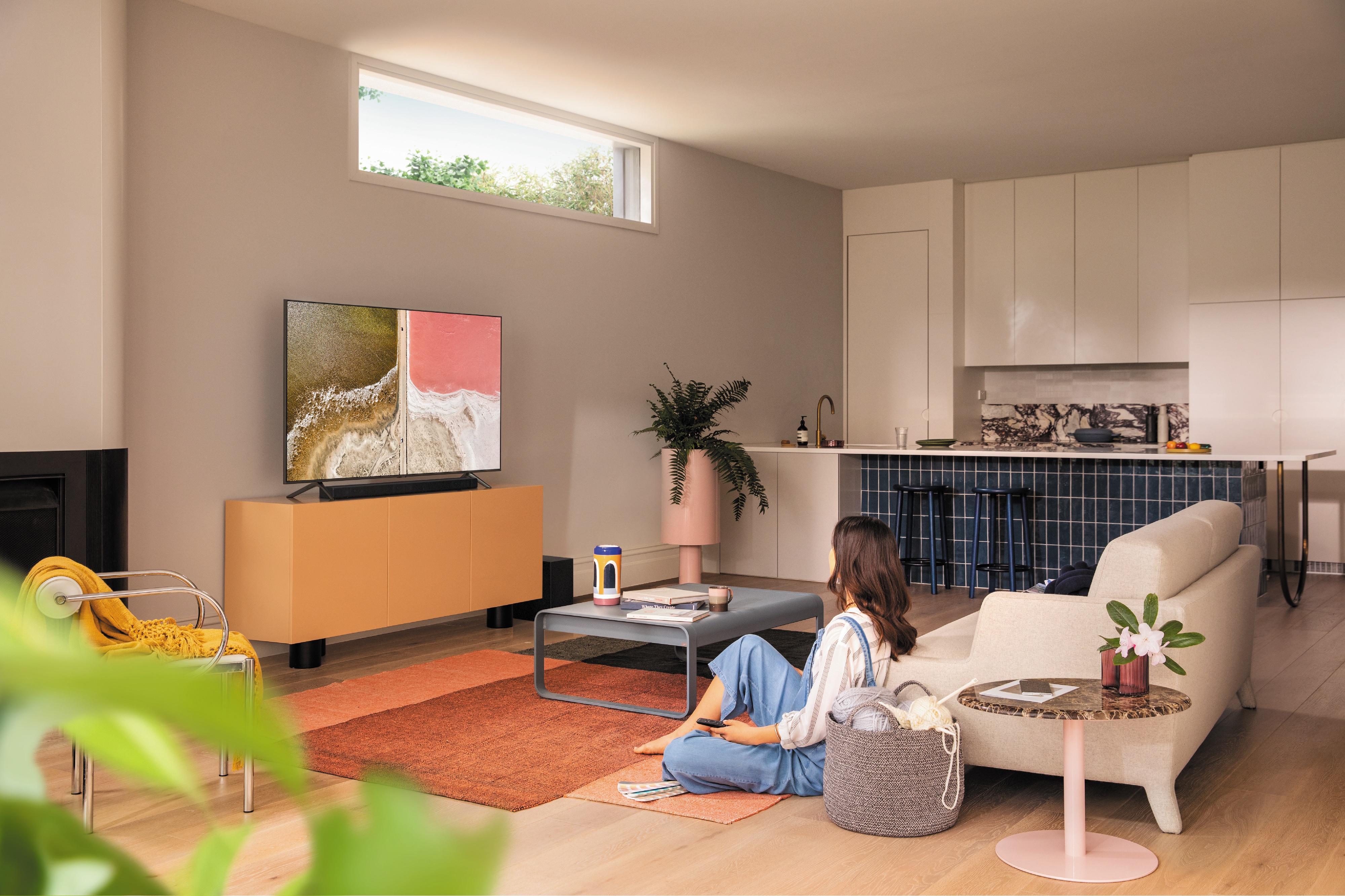 young woman watches content on Samsung TV in living room
