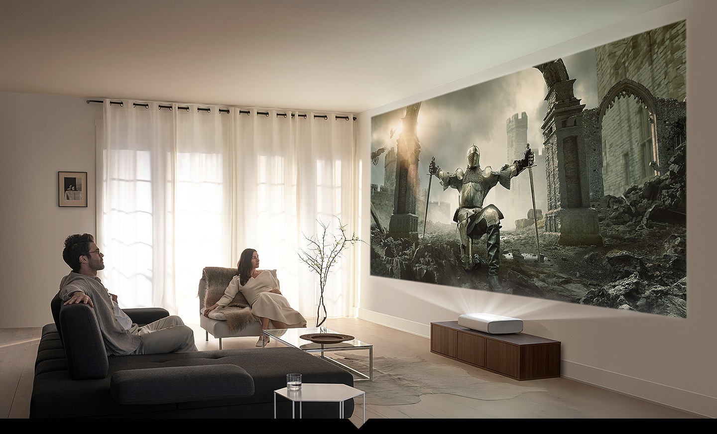 couple watches movie on wall with Samsung LSP9T 4K projector