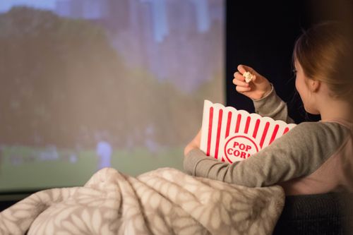 Child Watching Movie on Projector Screen