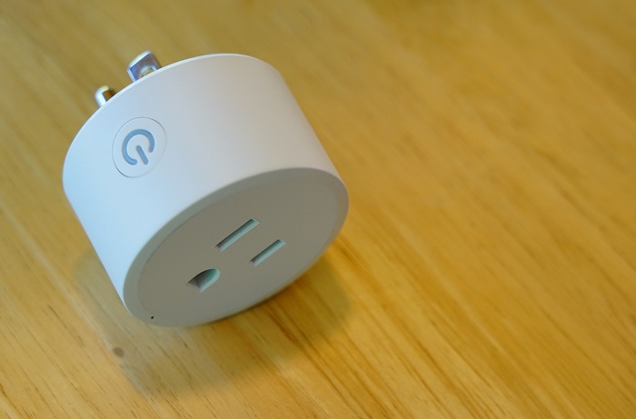 white smart power socket laying on hardwood floor