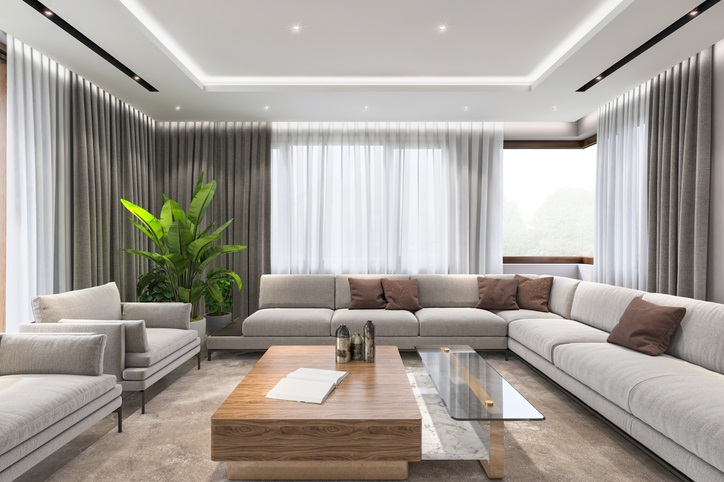Modern villa interior, large sofa and armchairs, coffee table and lot of sunlight