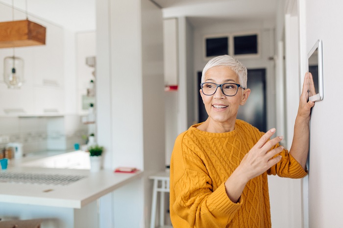 Woman using home automation controller