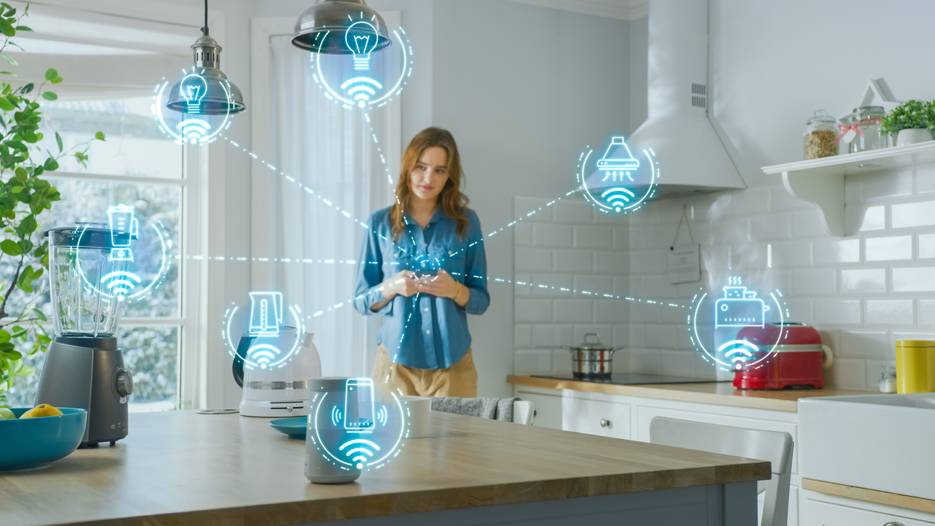young woman using smartphone in kitchen