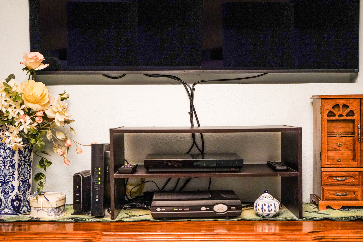 cords and wires show after installation of TV, VCR, DVD, router, cable box, and electronic WiFi device