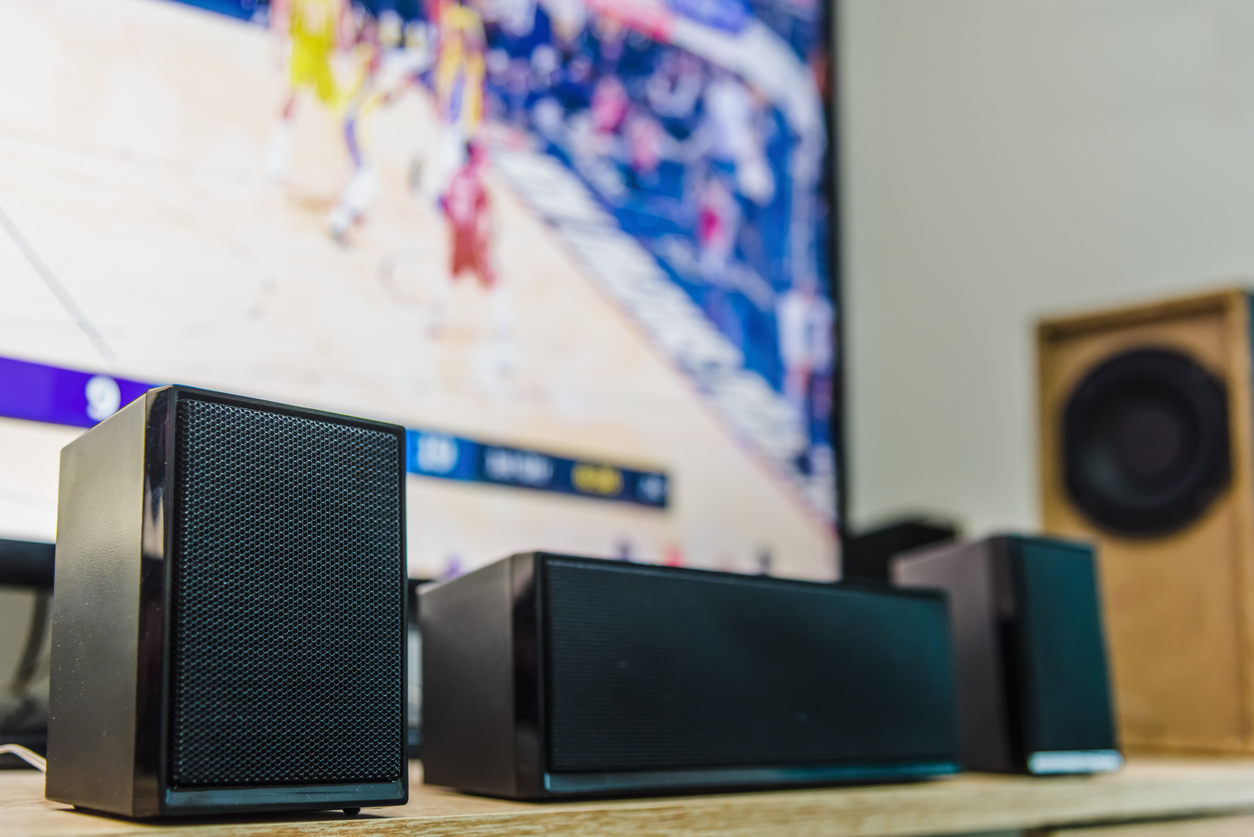 home theater speakers with a flat screen tv on the background