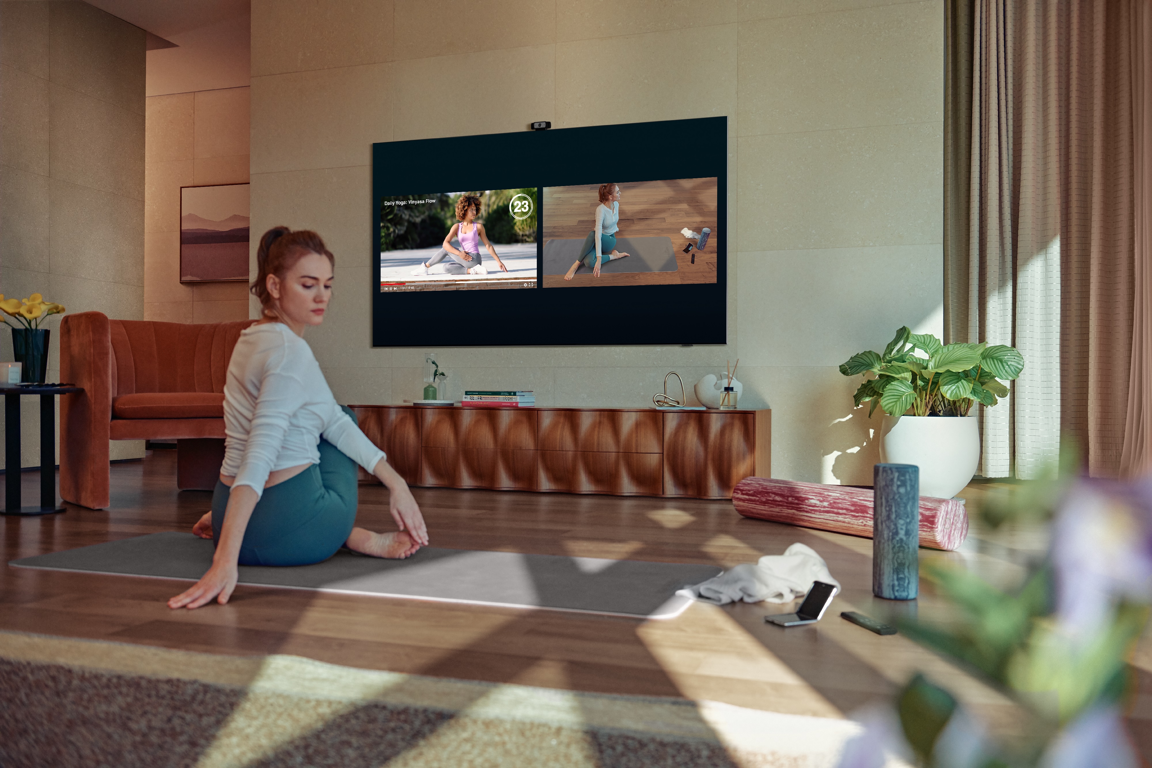 young woman does home workout with the help of Samsung QN85A TV