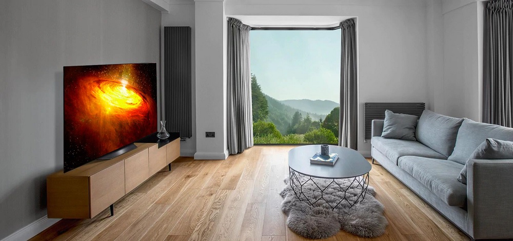 LG CX Class 4K Smart OLED TV sits on TV credenza in a rustic living room