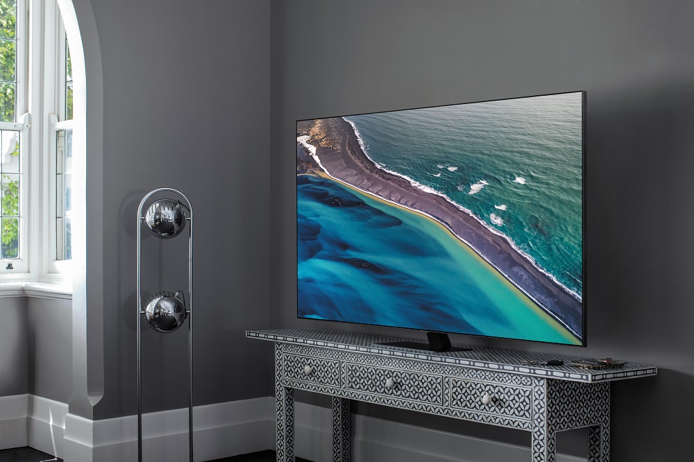 Samsung Class Q80T QLED TV sits on ornate TV stand in sunlit living room