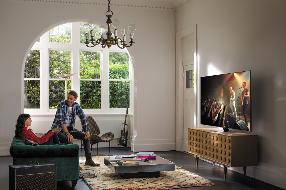 hipster young couple watch concert footage on Samsung TV