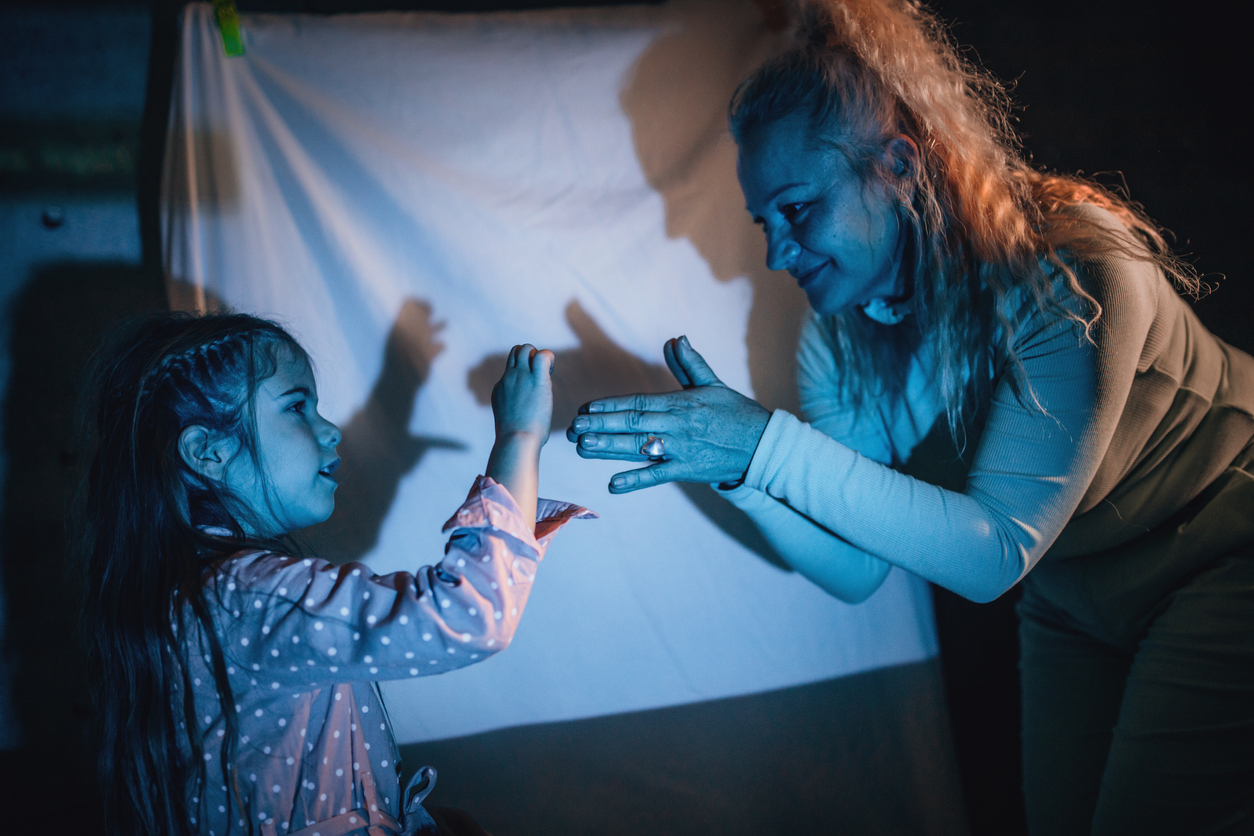  grandma and grandchild use projector screen for bedtime entertainment