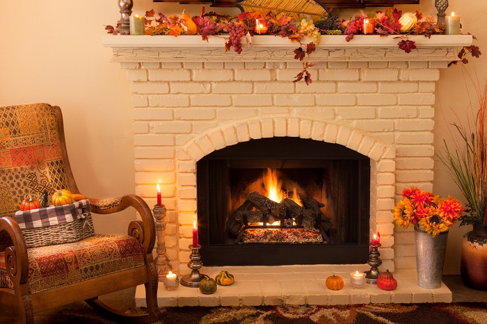 A fireplace covered with fall decor.