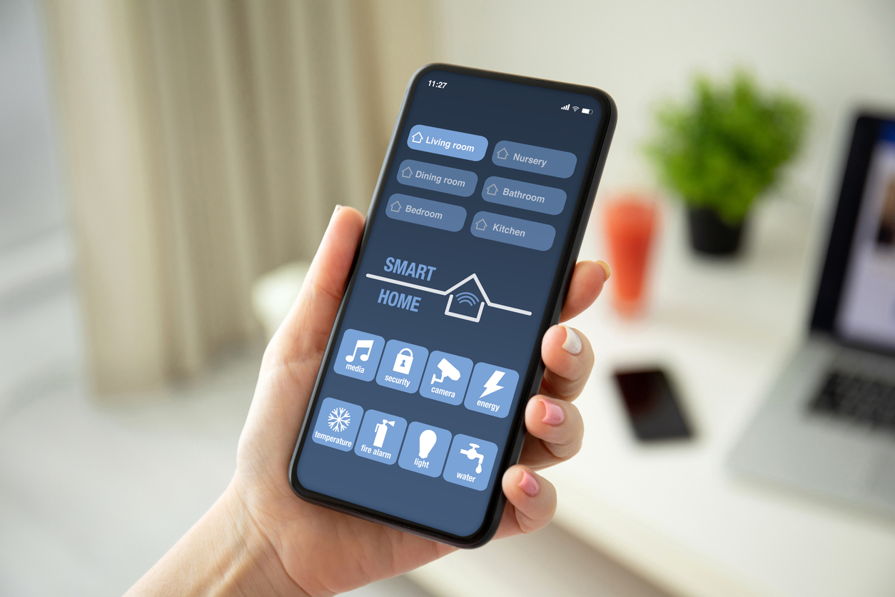 Hand holding a smart phone with a smart lock and security app